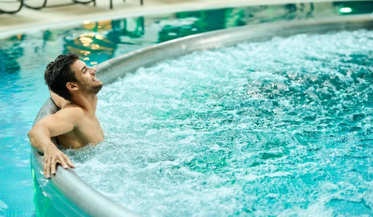 young relaxed man enjoying hot tub while spending day wellness center 637285 7406 1